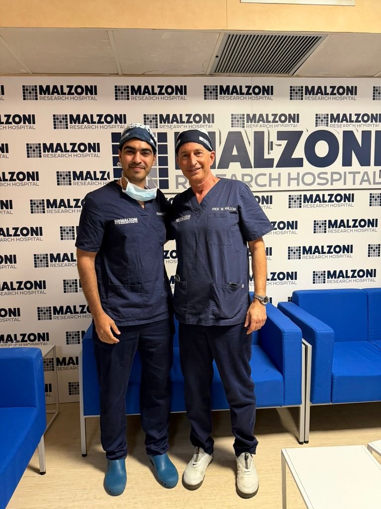 Dr. Arnav Pai with a surgical mentor during international training